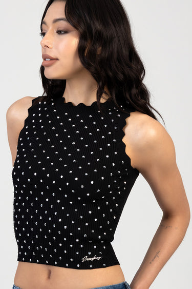 black ribbed knit sleeveless top with silver studs and a scalloped neckline, cropped at the waist.
