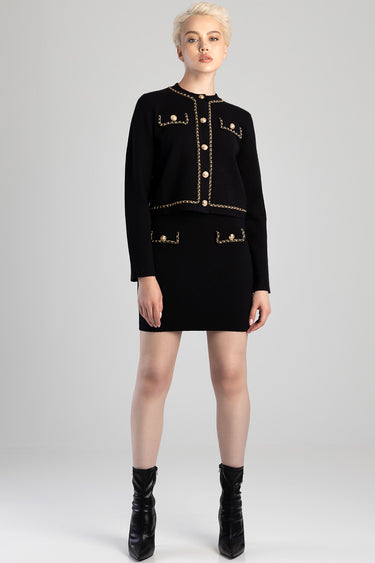 black knit cardigan with gold chain trim and matching mini skirt, button details, worn with black ankle boots