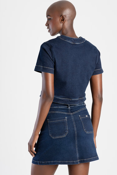 back view of a dark denim short sleeve top with visible contrast stitching, paired with a matching high waist denim mini
