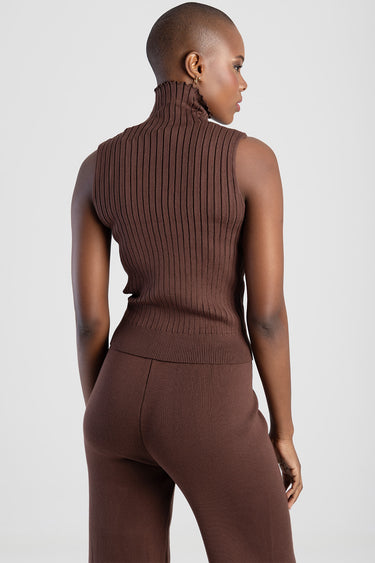 brown ribbed sleeveless knit top with a high turtleneck, back view on a model, with matching brown pants