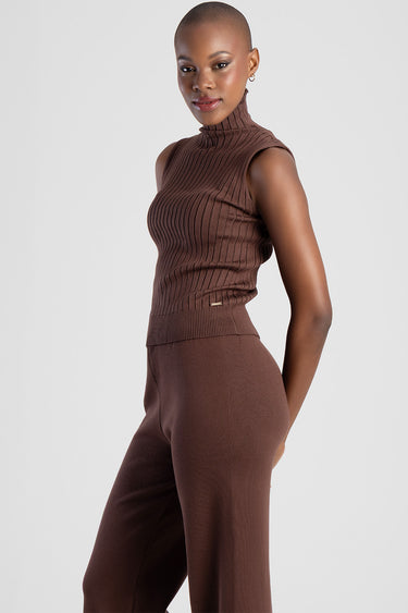 woman wearing a brown sleeveless ribbed knit turtleneck top and matching wide leg pants