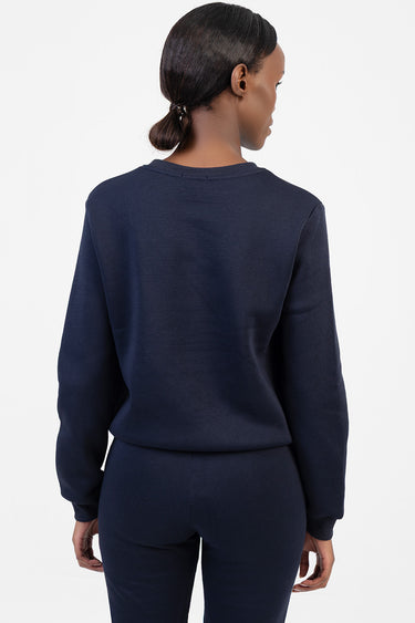 back view of a navy blue sweatshirt with matching pants worn by a model, by Blue Jean Traders