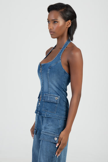 woman in blue denim halter top with front zip and pocket flaps featuring a heart charm