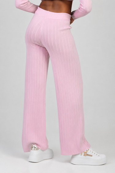 pink ribbed knit wide leg pants on model with white sneakers