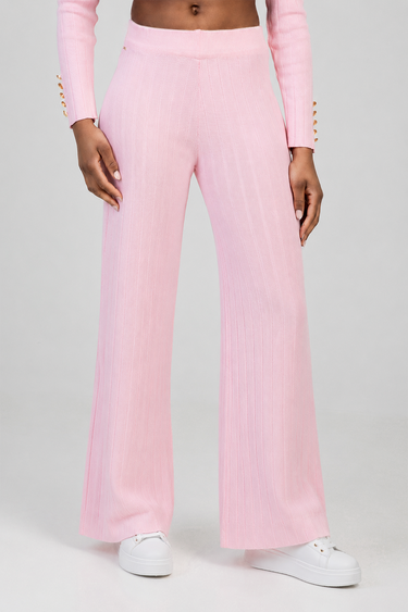 pink knit wide leg pants on a model, paired with white sneakers