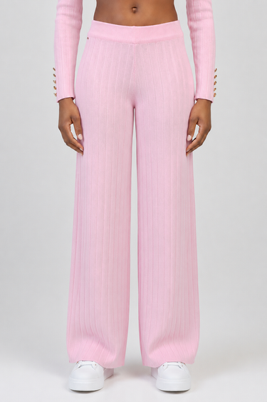 pink ribbed knit wide leg pants with high waist on a model wearing white sneakers