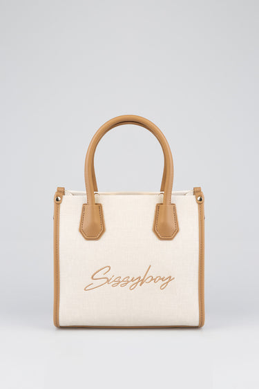cream canvas bag with tan leather trim and two rounded handles, front logo script