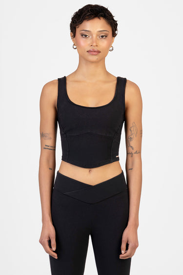 woman wearing black knit cropped tank top with wide straps and curved seam lines