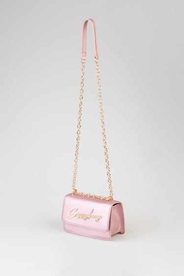 pink metallic crossbody bag with a gold chain strap and pink leather handle, gold script logo on the front
