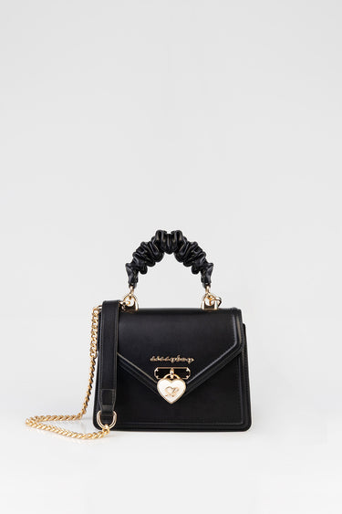 black leather handbag with a ruched black handle, gold chain strap, and a heart shaped gold lock