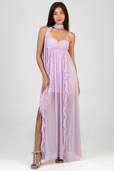 woman wearing lavender maxi dress with ruched bodice, sheer overlay, cascading ruffles, scarf neck, side slit, silver sandals