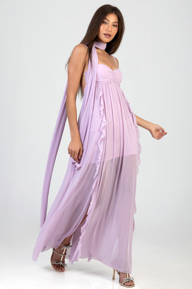 Blue Jean Traders woman wearing a lilac maxi dress with layered ruffles and a sheer skirt, with a matching scarf and silver