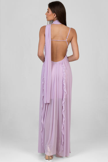 woman in a lavender maxi dress shown from behind with a long scarf draped over one shoulder and a ruffled side trim