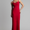 model wearing a red sleeveless maxi dress with thin straps and a small cutout at the neckline, full length against a grey