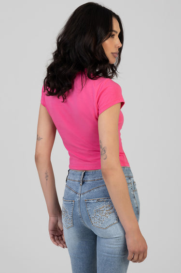 woman wearing a bright pink short sleeve t shirt by blue jean traders and light wash jeans, back view