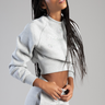 woman wearing a light gray cropped sweatshirt with pastel glitter butterfly motifs and matching joggers